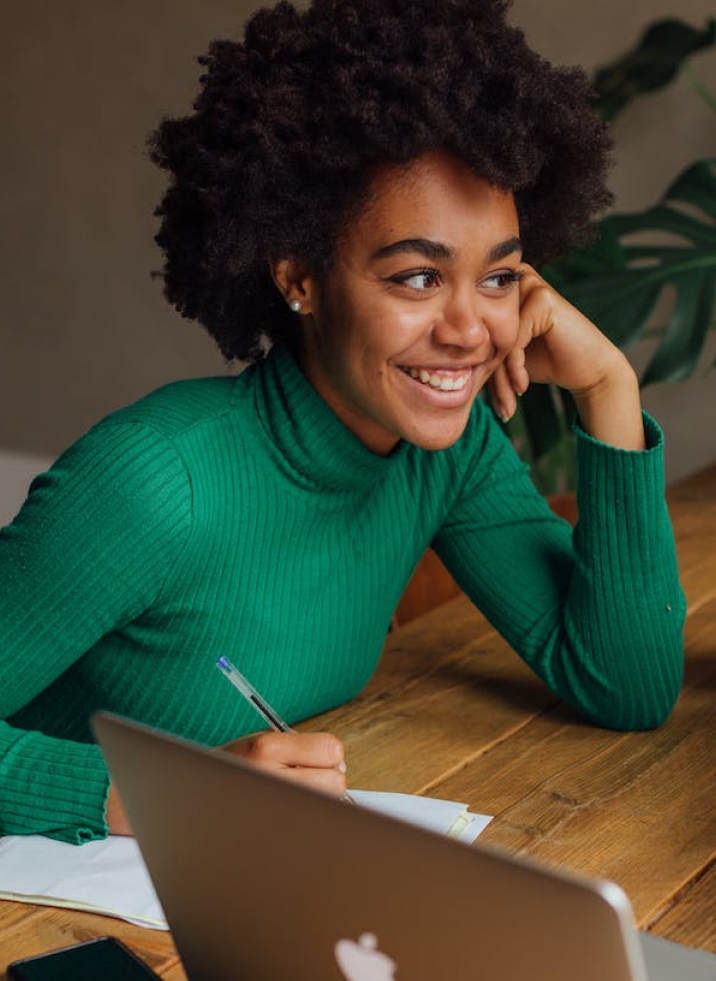 girl smilling while writing